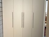 a room with white cupboards and a black ceiling