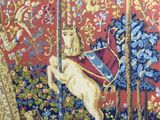 a tapestry with a picture of a man riding a horse in a forest