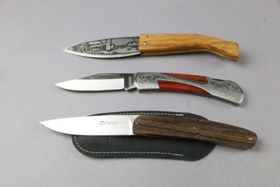 three different types of knives sitting on a table