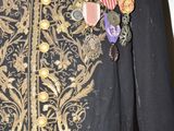a black jacket with a gold and silver design on it