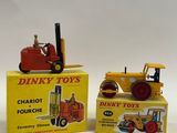 two toy tractors sitting next to each other on a table