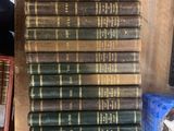 several old books are stacked on top of each other on a table
