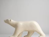 a white sculpture of a polar bear on a white surface