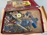 a box full of assorted metal parts and tools
