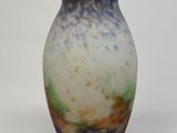 a blue and white vase sitting on a white surface