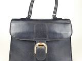 an image of a black leather handbag with a gold buckle