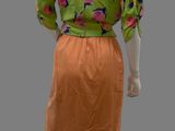 an image of a mannequin wearing a green and orange dress