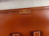 a brown leather handbag with the letter h on it