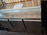 two refrigerators that are next to each other in a room