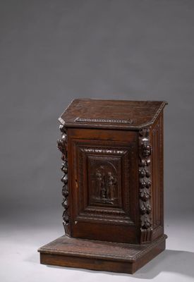 une vieille armoire en bois ornée de sculptures sur la façade et les côtés