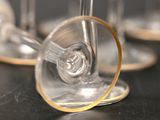 several empty wine glasses sitting on top of a black table