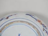 a blue and white plate with a bird on it