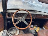 a steering wheel and dashboard of an old car