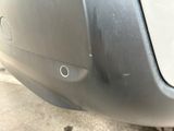 a close up of a car ' s bumper with a hole in it
