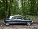 a black car that is parked in the dirt