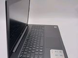a laptop computer sitting on a table with a keyboard