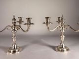 pair of silver plated candelabs with angels on each of them