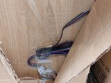 a cardboard box with wires in it sitting on the floor