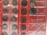 many different types of coins in a display case