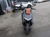 une moto garée sur un parking à côté d'un immeuble