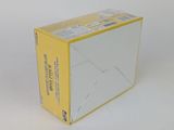 a white box with a yellow lid sitting on a white surface