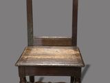 an old wooden chair with a mirror on the back of it