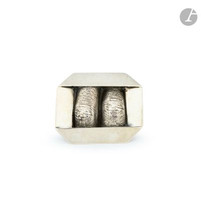 two silver balls in a silver box on a white surface