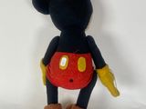 disney mickey mouse plush toy sitting on a white surface