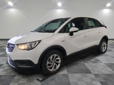 the white car is parked on a checkered floor in the garage