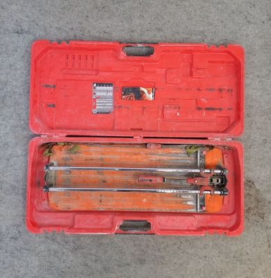 a red tool case with tools in it on the ground