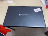 a laptop that is sitting on a desk in a room