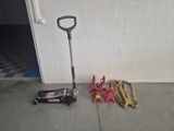tools that are sitting on the floor next to a tool stand