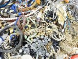 a pile of assorted jewelry on a white surface