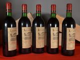 four bottles of wine are lined up on a table