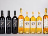 six bottles of wine are lined up in a row