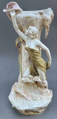 a statue of a woman holding a shell in her hand