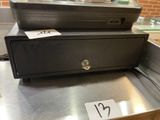 a cash register sitting on top of a metal counter