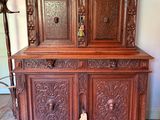 a wooden cabinet with a door and a lamp on top of it