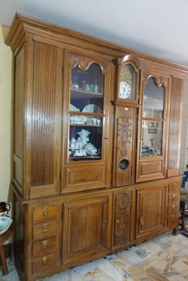 an image of a wooden china cabinet in a living room