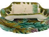 a green and white dish with pineapples on it