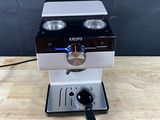 a close up of a coffee machine on a wooden table