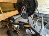 a machine that is sitting on the floor next to a bench