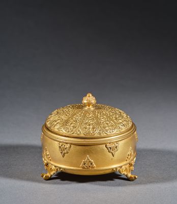 a gold plated box with a decorative design on the lid