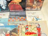 several children ' s books are sitting on a table with a red hat