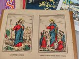 many books on the table with pictures of jesus and other religious items
