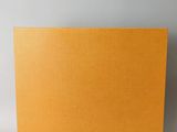 a close up of a yellow box on a white surface