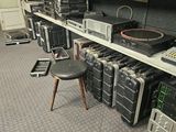 many different types of electronics on the shelves in this room