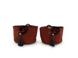 two brown baskets with tassels on them on a white background