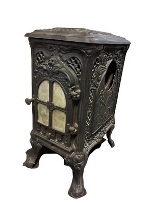un petit poêle noir surmonté d'une porte vitrée