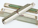 several rolls of paper are wrapped in green and white paper